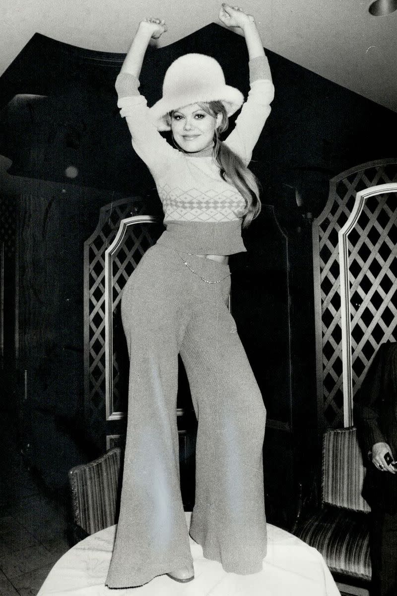 <p> Side ponytails dominated the scene in 1974, as seen here on Charo. They were usually clasped low at the nape of the neck and typically un-curled. A sporty, chic look. </p>