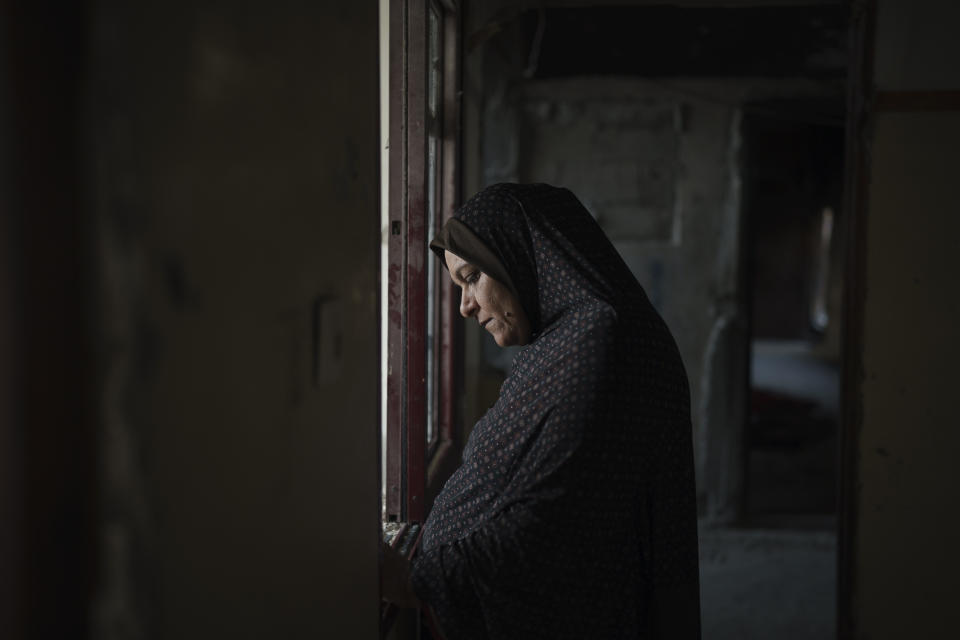 Jawaher Nassir stands inside her home, heavily damaged by airstrikes during an 11-day war between Israel and Hamas, the militant group that controls Gaza, Friday, June 11, 2021, in Beit Hanoun, northern Gaza Strip. (AP Photo/Felipe Dana)