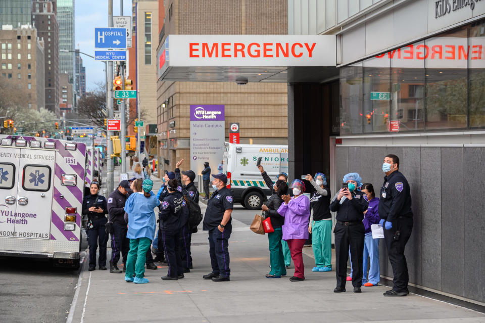 NEW YORK, NY - APRIL 04: Medical personnel are seen outside NYU Langone Health hospital as people applaud to show their gratitude to medical staff and essential workers working on the front lines of the coronavirus pandemic as the country works to stop the spread of COVID-19 on April 4, 2020 in New York City. The coronavirus (COVID-19) pandemic has spread to at least 180 countries and territories across the world, claiming over 60,000 lives and infecting hundreds of thousands more. (Photo by Noam Galai/Getty Images)