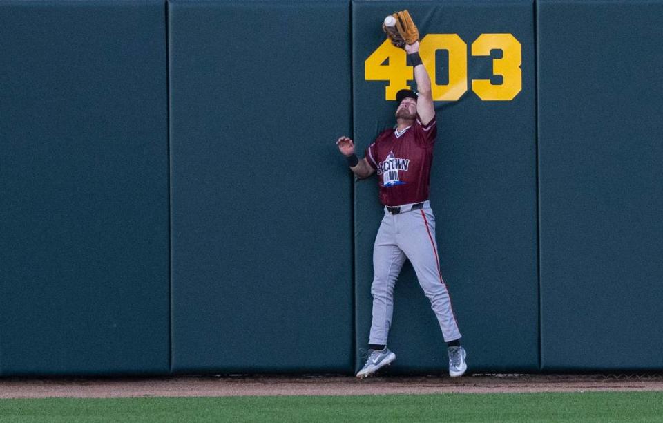 River Cats’ centerfielder Brett Wisely catches a ball against the wall as they play the San Francisco Giants in an exhibition game Sunday.