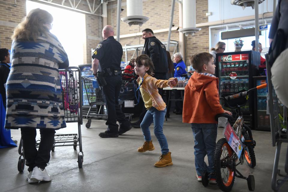 Kaitlin Yearty, 6, dances to the music as she waits to check out during the Columbia County Sheriff's Office Day with a Deputy at Walmart on Thursday, Dec. 21, 2023.