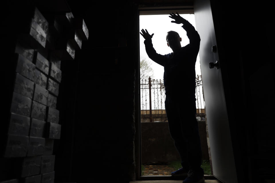 Troy Hernandez, environmental justice activist with Pilsen Environmental Rights and Reform Organization is silhouetted at the basement where he replaced the lead service water lines with copper pipes, Friday, April 9, 2021 in Chicago's Pilsen neighborhood. President Joe Biden’s proposal to get rid of every lead water pipe in the country could have huge ramifications. That's especially true in communities where a large number of Black, Latino and low-income residents have been left effectively drinking from a lead straw. The problem persists decades after scientists established that lead consumption is unsafe at any level. Biden announced the pipe proposal as part of his $2.3 trillion infrastructure package. (AP Photo/Shafkat Anowar)