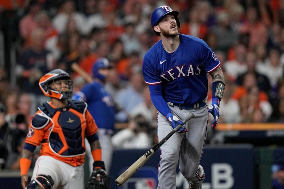 Texas Rangers’ Jonah Heim hits a two-run home run during the fourth inning of Game 6 of the baseball AL Championship Series against the Houston Astros Sunday, Oct. 22, 2023, in Houston. (AP Photo/David J. Phillip)
