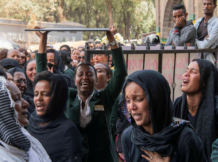 Ethiopian Airlines crew members mourn as pallbearers carry the coffins of their colleagues of the Ethiopian Airline Flight ET 302 plane crash, during the burial ceremony at the Holy Trinity Cathedral Orthodox church in Addis Ababa, Ethiopia, March 17, 2019. REUTERS/Maheder Haileselassie