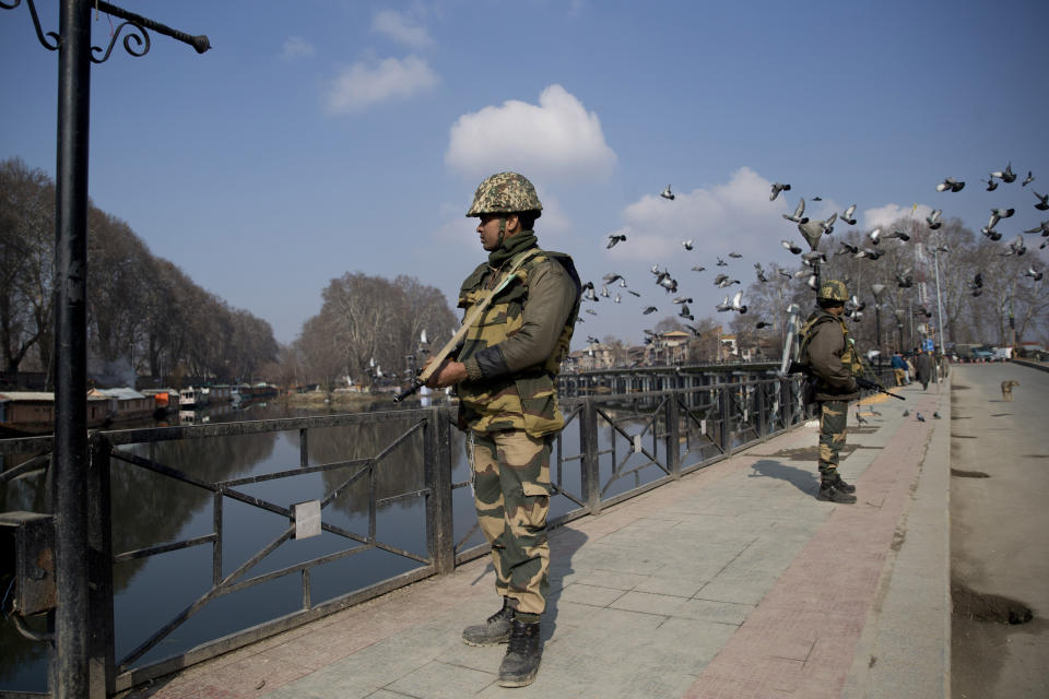 Indian paramilitary soldiers stand guard on a deserted street during a strike in Srinagar, Indian controlled Kashmir, Sunday, Feb. 3, 2019. India's prime minster is in disputed Kashmir for a daylong visit Sunday to review development work as separatists fighting Indian rule called for a shutdown in the Himalayan region. (AP Photo/Dar Yasin)