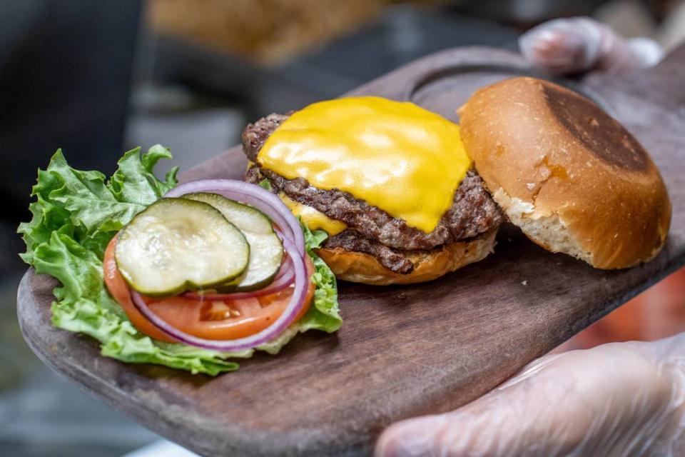 A burger at Bang Bang Burgers with two patties, American Cheese, onion, pickles, tomato, lettuce and a toasted bun. Alex Cason/CharlotteFive