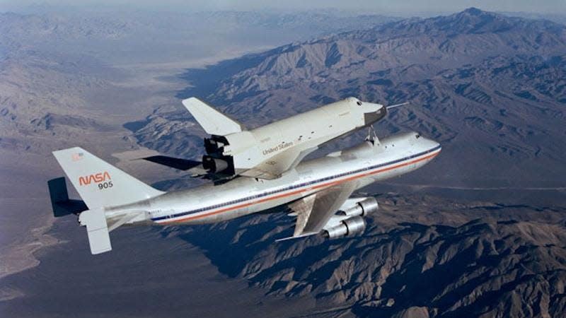 Enterprise mounted to the top of a modified Boeing 747 during OV-101 Flight 7 on October 12, 1977. The Shuttle’s Tail Cone was removed for this mission, exposing its mock engines. 