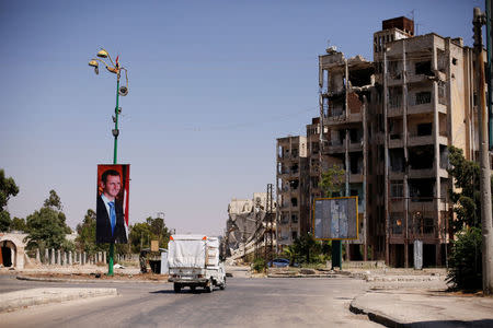 A picture of Syria's President Bashar al-Assad is seen in Waer district in the central Syrian city of Homs, Syria July 26, 2017. Picture taken July 26, 2017. REUTERS/Omar Sanadiki