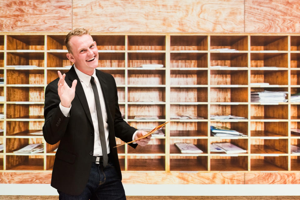 A man smiling in the mailroom