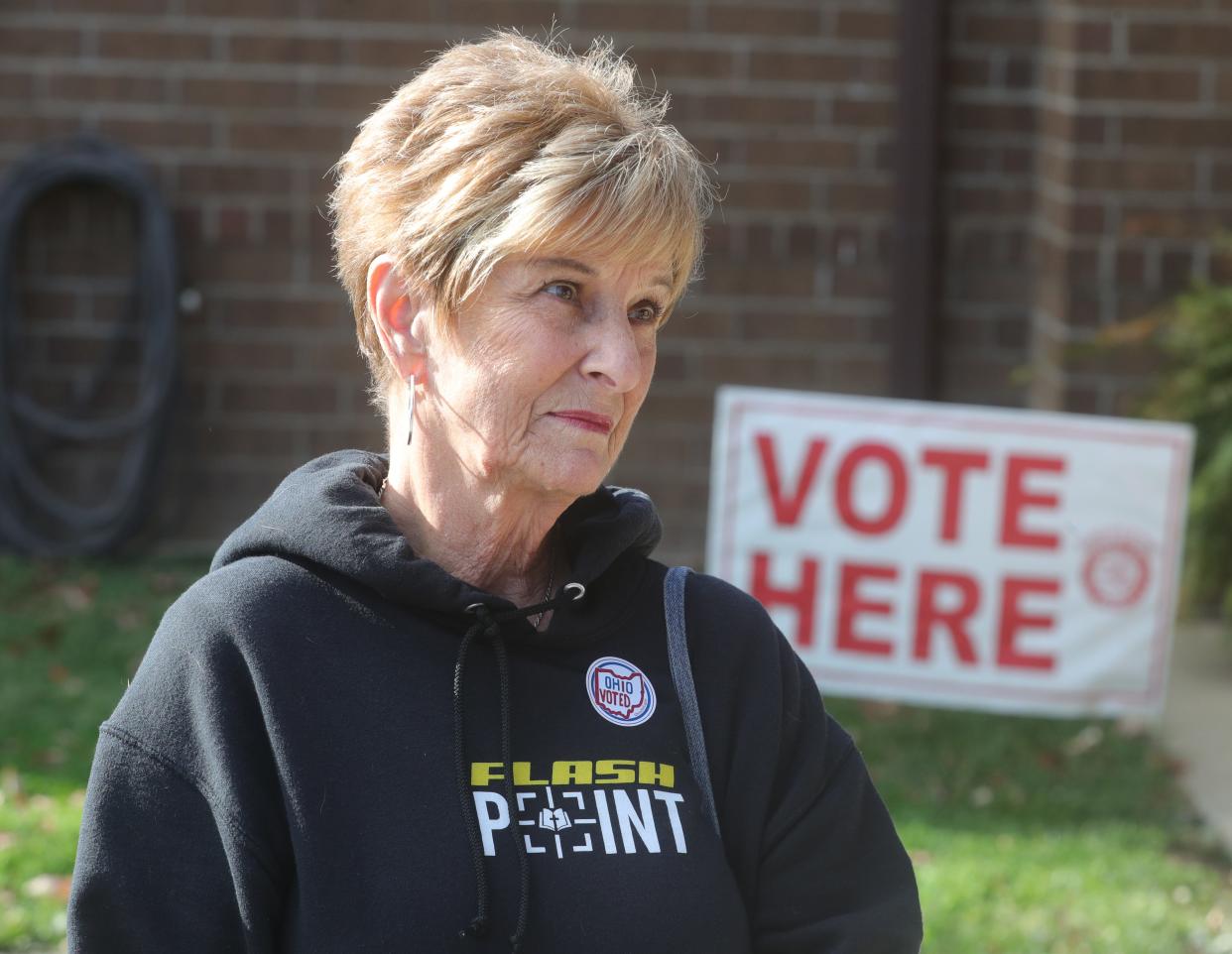 Linda Carter talks about casting her vote on issues 1 and 2 outside the polling place on Tuesday in Norton.