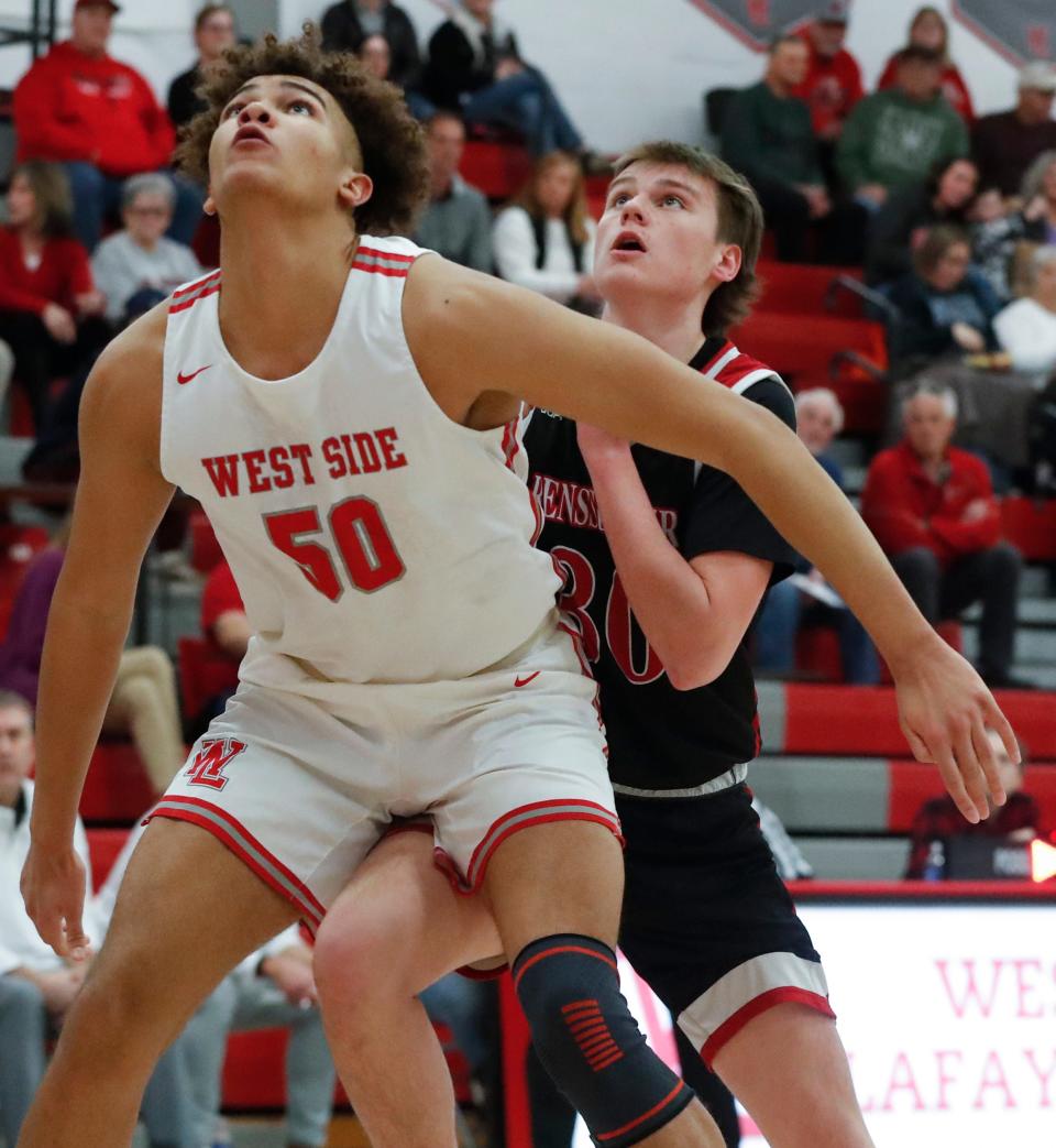 West Lafayette Red Devils center Kevo St. Hilaire (50) boxes out Rensselaer Central Bombers Dalton Lynch (30) during the IHSAA basketball doubleheader, Thursday, Jan. 11, 2024, at West Lafayette High School in West Lafayette, Ind.