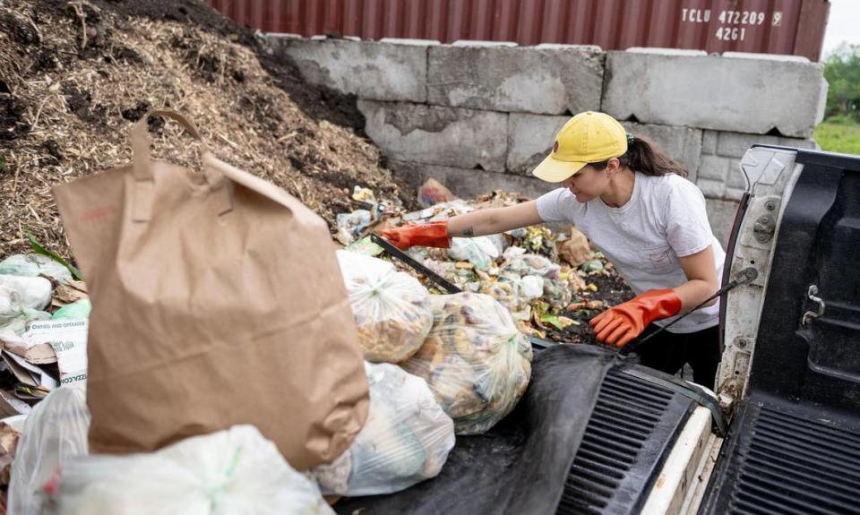 Romi Shaw empties customers’ food waste into a pile as part of her work for Compost Collective KC. The operation hauls food waste from more than 3,000 households back to Urbavore, where a composting facility turns what would otherwise be landfill-destined trash into nutrient-rich soil.