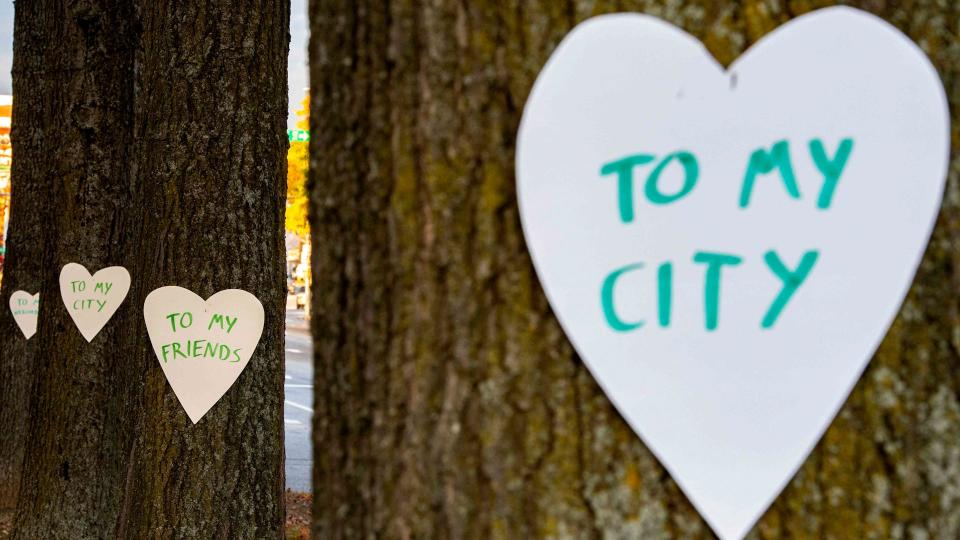 Hearts with messages are hung all over the downtown area in Lewiston, Maine on October 26, 2023, in the aftermath of a mass shootings. Hundreds of police in the US state of Maine hunted October 26, 2023 for a fugitive gunman who killed 18 people at a bowling alley and a bar, as President Joe Biden mourned "yet another senseless and tragic mass shooting." Police named the suspect as 40-year-old Robert Card -- seen in surveillance footage pointing a semi-automatic rifle as he walked into the Sparetime Recreation bowling alley.