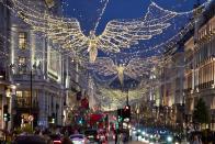 Christmas lights are displayed on Regent Street, in London, Thursday, Nov. 24, 2022. In cities across Europe, officials are wrestling with a choice this Christmas. Dim lighting plans to send a message of energy conservation and solidarity with citizens squeezed by both higher energy costs and inflation or let the lights blaze in a message of defiance after two years of pandemic-suppressed Christmas seasons, creating a mood that retailers hope loosen holiday purses. (AP Photo/Kin Cheung)