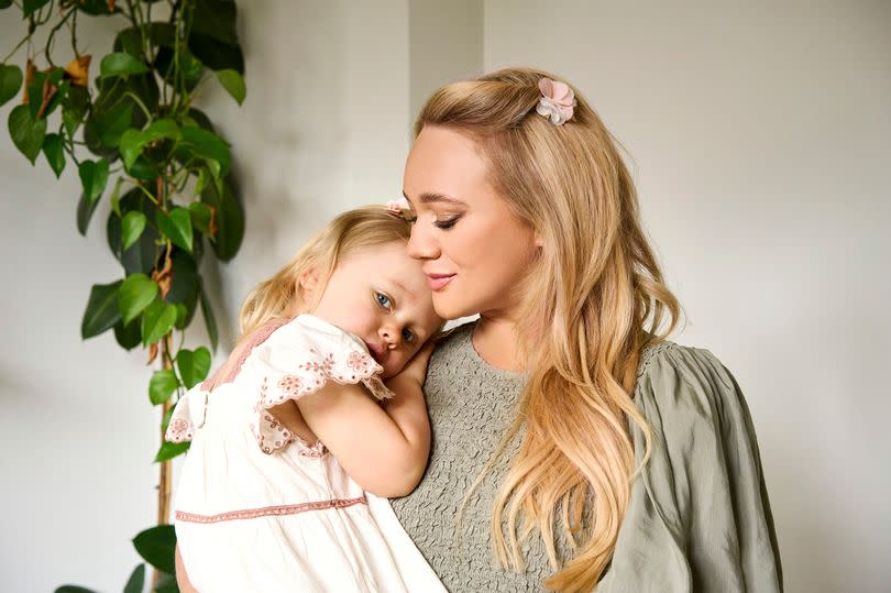 Kirsty-Leigh Porter's daughter Nala Rai rests her  head on her mum's shoulder