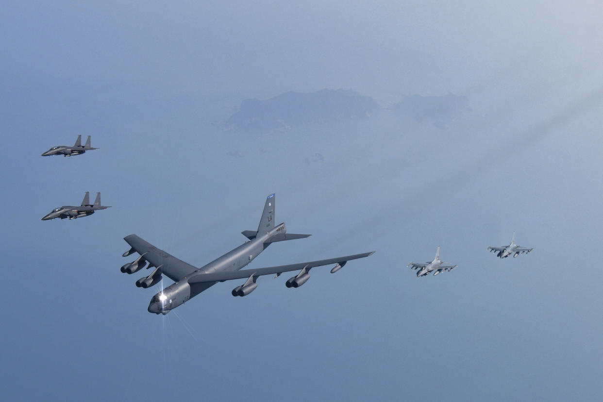 In this photo provided by South Korea Defense Ministry, a U.S. Air Force B-52H Stratofortress aircraft, center, flies in formation with South Korea's Air Force KF-16 fighters and South Korea's Air Force F-15K fighters over the western sea of Korean peninsula during a joint air drill in South Korea, Monday, March 6, 2023.(South Korea Defense Ministry via AP)