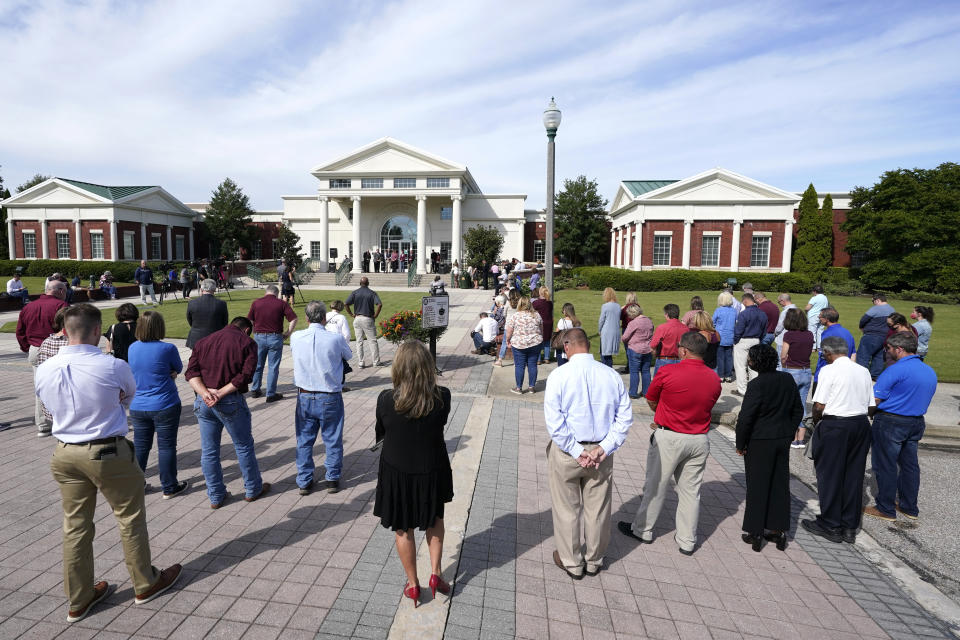 People attend a prayer vigil at the Collierville Town Hall Friday, Sept. 24, 2021, in Collierville, Tenn. The vigil is for the person killed and those injured when a gunman attacked people in a Kroger grocery store Thursday before he was found dead of an apparent self-inflicted gunshot wound. (AP Photo/Mark Humphrey)