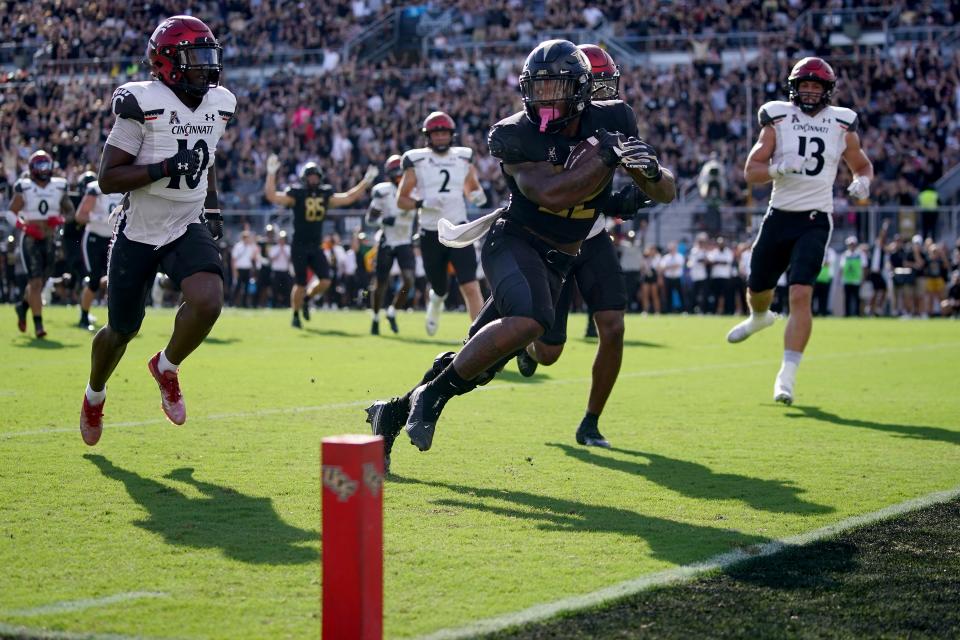 UCF Knights running back RJ Harvey (22) scores a touchdown in the first quarter during a college football game against the Cincinnati Bearcats, Saturday, Oct. 29, 2022, at FBC Mortgage Stadium in Orlando, Fla. The UCF Knights lead at halftime, 10-6.