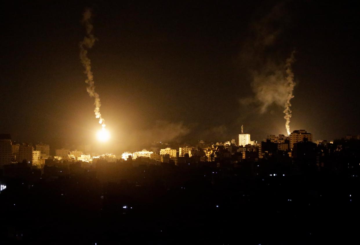 An Israeli army flare illuminates the sky above the northern Gaza strip, on, 11 October 2023 (EPA)