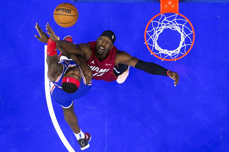 Philadelphia 76ers' Paul Reed, right, goes up for a shot against Miami Heat's Bam Adebayo during the first half of an NBA basketball game, Wednesday, Feb. 14, 2024, in Philadelphia. (AP Photo/Matt Rourke)