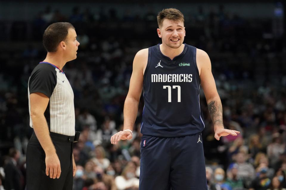 Referee Mark Lindsay, left, talks to Dallas Mavericks' Luka Doncic after a play in the second half of an NBA basketball game against the New Orleans Pelicans in Dallas, Monday, Nov. 8, 2021. (AP Photo/Tony Gutierrez)