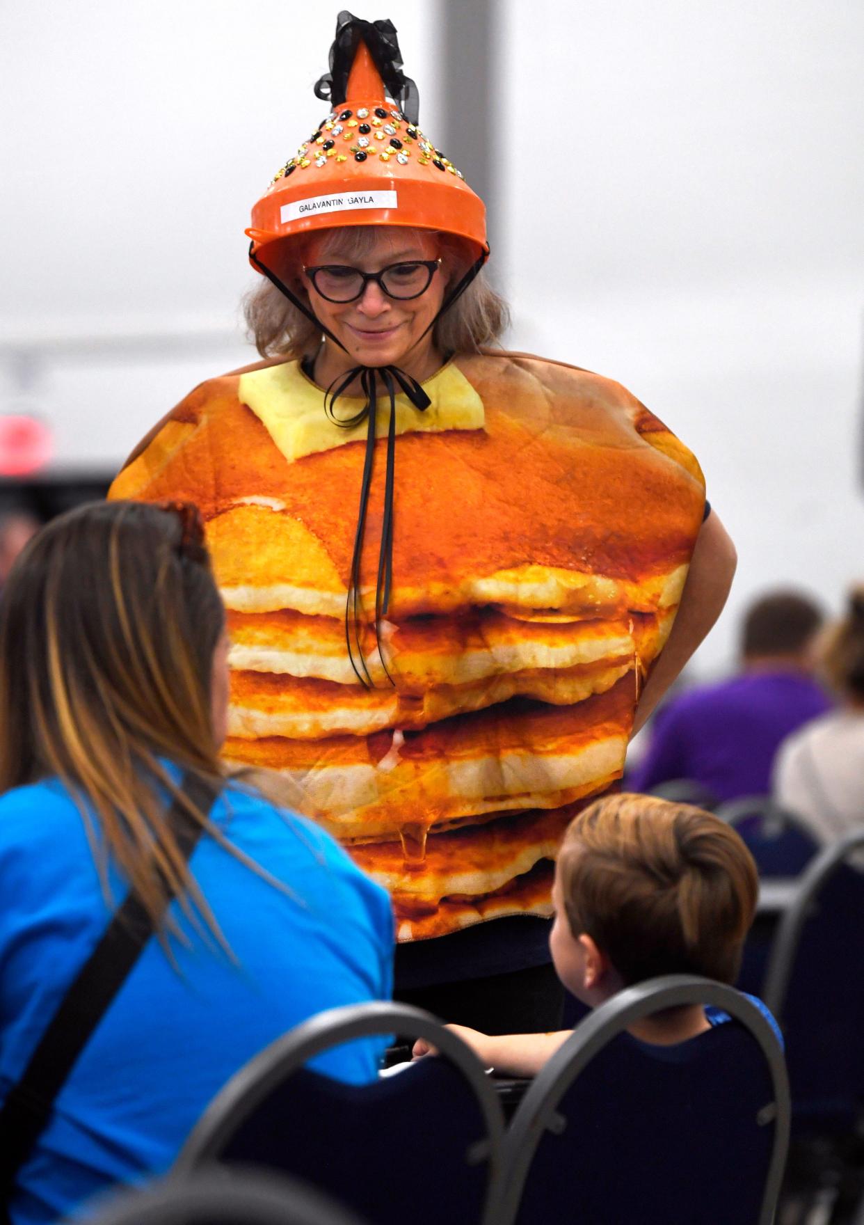 Gayla Mize, dressed for Pancake Day at the Abilene Convention Center Saturday, chats with some of the younger members of the crowd.