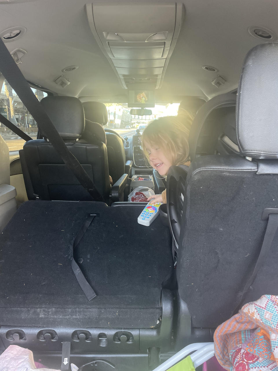 Chelsea Long's daughter, in the back of their neighbor's van waiting for her dad to find their 10 pieces of luggage after their Christmas Eve flight was canceled. (Courtesy Chelsea Long)