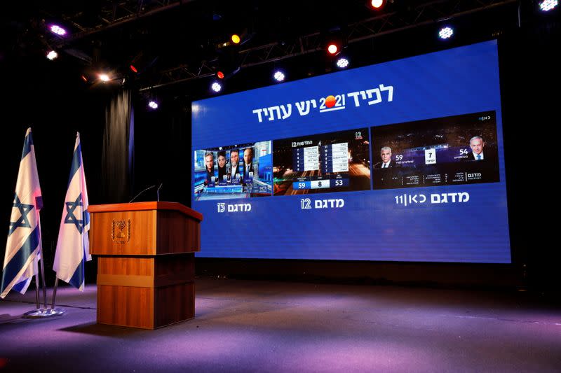 The results of the exit polls in Israel's general election are shown on a screens at Yair Lapid's Yesh Atid party headquarters in Tel Aviv