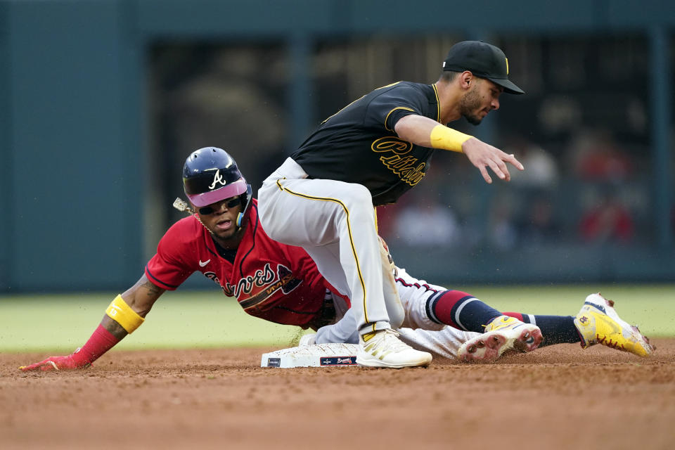 Atlanta Braves' Ronald Acuna Jr. (13) is tagged out by Pittsburgh Pirates second baseman Tucupita Marcano on an attempted steal during the third inning of a baseball game Friday, June 10, 2022, in Atlanta. (AP Photo/John Bazemore)
