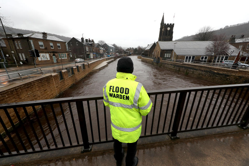 A flood warden looks at the water levels of the River Calder in Mytholmroyd in the Upper Calder Valley, West Yorkshire, in anticipation of Storm Christoph.