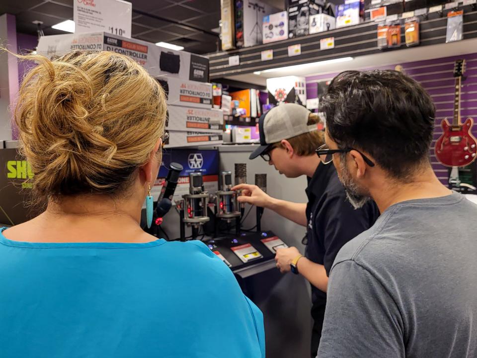 Selene Zamorano-Ochoa and Jesus Rodriguez shop for microphones on Tuesday, September 6, at Guitar Center in Sioux Falls. The microphone will be used for a Spanish radio station, which the South Dakota Hispanic Chamber of Commerce plans to start in February 2023.