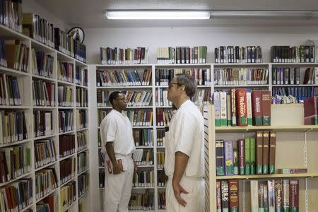 Offenders search for books at a library inside the Southwestern Baptist Theological Seminary located in the Darrington Unit of the Texas Department of Criminal Justice men's prison in Rosharon, Texas August 12, 2014. REUTERS/Adrees Latif