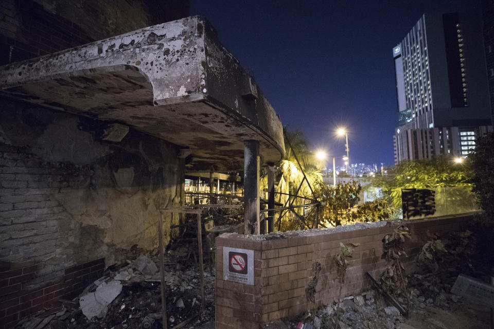 This Friday, Nov. 22, 2019, photo, shows heavy damages to a side entrance linking to the city from the Hong Kong Polytechnic University campus after a battle between students and police in Hong Kong. Most of the protesters who took over the university have left following clashes with police, but an unknown number have remained inside, hoping somehow to avoid arrest. (AP Photo/Vincent Thian)