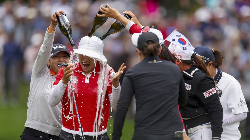 Yang is doused with champagne on the 18th green. - Ezra Shaw/Getty Images