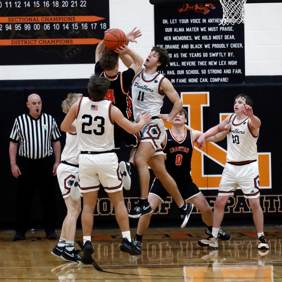 Lukas Ratliff defends Landen Wilson's last-second shot as time expired in regulation during New Lexington's 49-43 win against visiting Ironton on Saturday during a Division II sectional final in New Lexington. The Tigers came up empty on two game-winning shots in the final seconds of regulation.