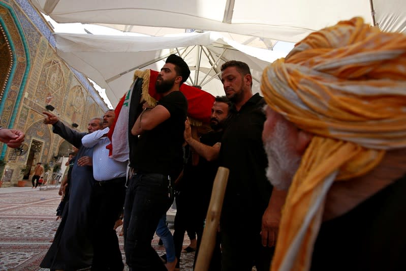 Mourners carry the coffin of a demonstrator who was killed at anti-government protests, during a funeral in Najaf