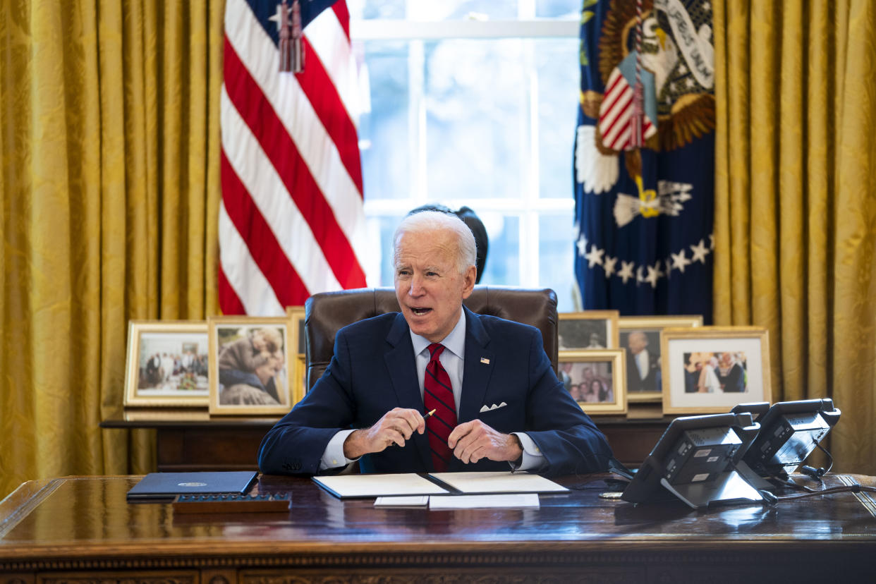 President Joe Biden signs executive actions on health care in the Oval Office of the White House on January 28 in Washington, D.C.