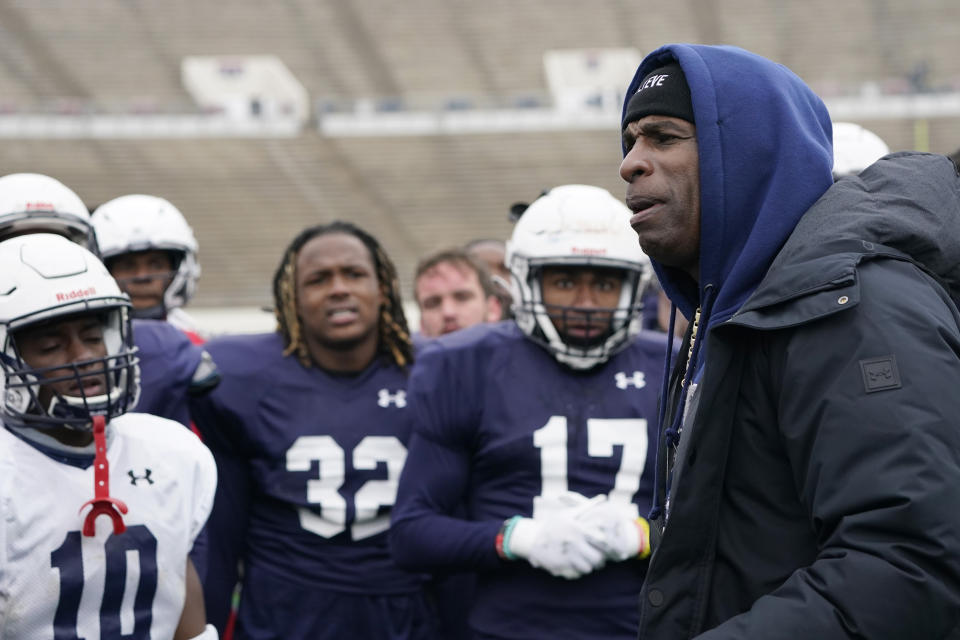 Jackson State football coach Deion Sanders speaks with players following an NCAA college football scrimmage in Jackson, Miss., Saturday, Feb. 13, 2021. This is Sanders' first college head coaching position. (AP Photo/Rogelio V. Solis)