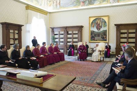 Pope Francis (R) listens to the Archbishop of Canterbury Justin Welby during a private meeting at the Vatican June 16, 2014. REUTERS/Osservatore Romano
