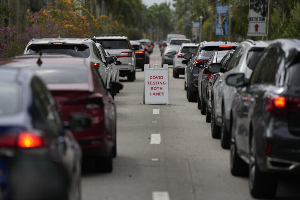 FILE - People wait in line in their cars to be tested for COVID-19 at a drive-thru testing site at Zoo Miami, Monday, Jan. 3, 2022, in Miami. The explosive increase in U.S. coronavirus case counts is raising alarm, but some experts believe the focus should instead be on COVID-19 hospital admissions. And those aren't climbing as fast. (AP Photo/Rebecca Blackwell)