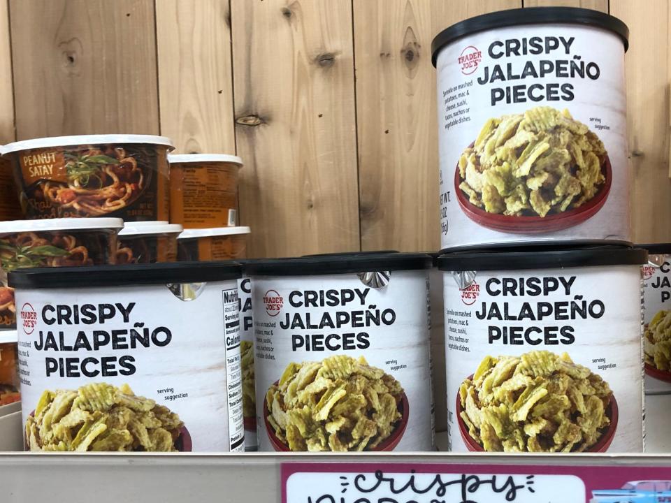 Containers of crispy-jalapeño pieces on a shelf at Trader Joe's. The price tag on the shelf reads $3.