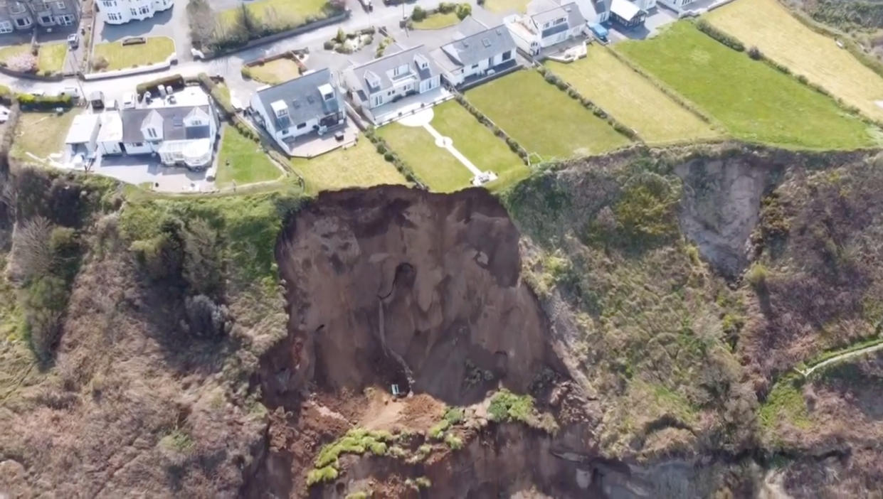 A giant landslide slid onto a beach today - only minutes after people had walked on the sand.

Large parts of clifftop gardens - and even a wooden bench - were carried onto the beach in the fall.
 
Police were urging people to stay away from the landslide at Nefyn near Pwllheli, North Wales, in case of more falls.

Hairdress Christian Pilling said: 