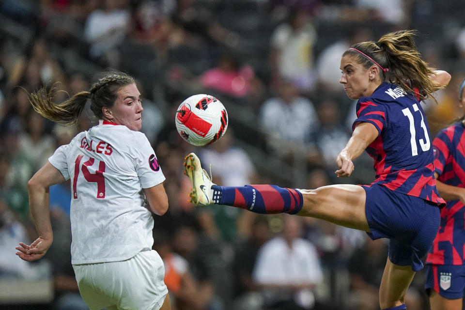 United States' Alex Morgan, right, controls the ball against Canada's Vanessa Gilles during the CONCACAF Women's Championship final soccer match in Monterrey, Mexico, Monday, July 18, 2022. (AP Photo/Fernando Llano)