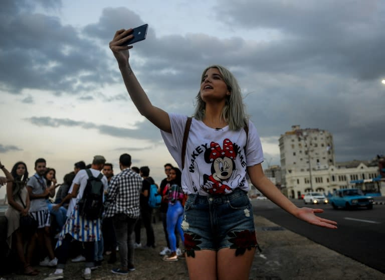 A Cuban youtuber records her youtube program at Havana's seaside Malecon