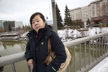 Jian Zhen Huang, who applied for a United States U visa based on being victimized in an attack on the street while visiting New York City, poses near her current home in Fairbanks, Alaska, October 13, 2014. REUTERS/Charles Mason