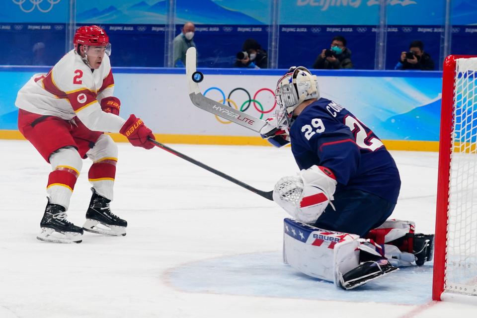 Team USA goalkeeper Drew Commesso, right, turns aside a shot from China's Liu Jie during a preliminary round men's hockey game at the 2022 Winter Olympics on Thursday, Feb. 10, 2022, in Beijing.