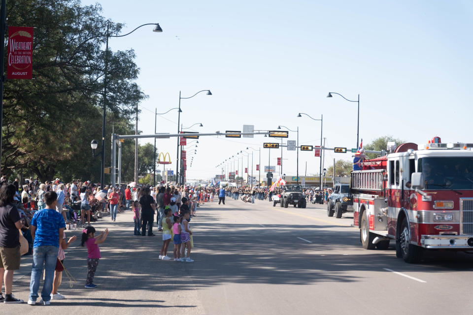 The crowd cheers as emergency vehicles pass them at the 104th annual Wheatheart of the Nation Parade on Aug. 19 in Perryton.