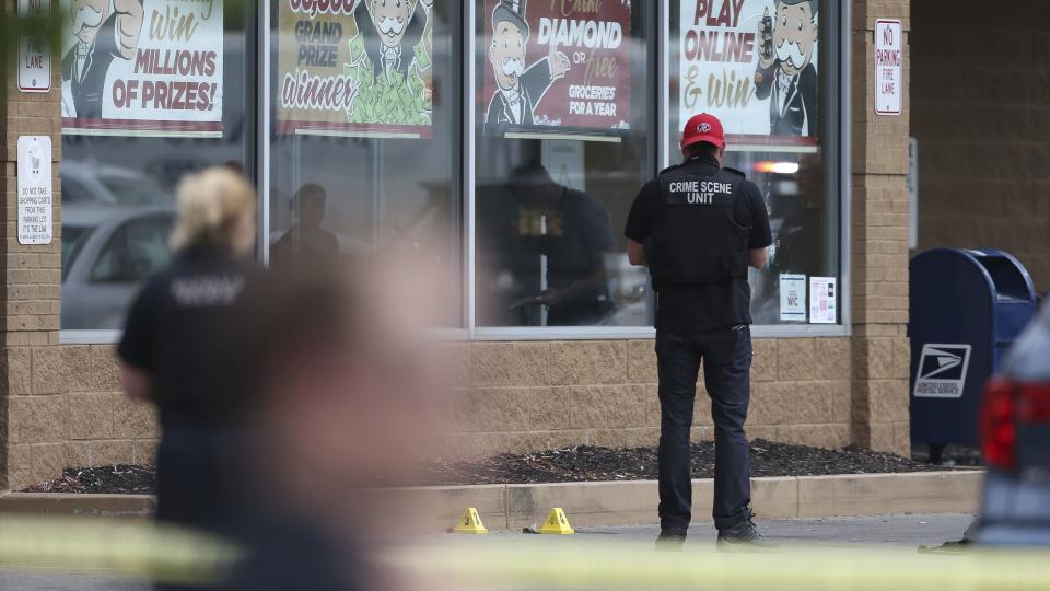 Police investigate after a shooting at a supermarket, Saturday, May 14, 2022, in Buffalo, N.Y. (AP Photo/Joshua Bessex)