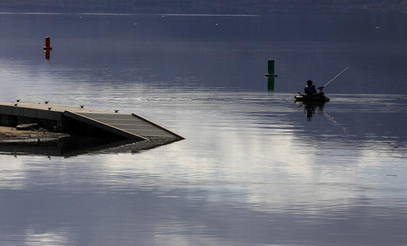 LAKE ELSINORE,, CA. MARCH 1, 2024: Float Fisherman Johnathan O. Skinner casts his line near one of the submerged docks at Launch Pointe on Lake Elsinore. After a series of heavy rainstorms hit Southern California, water levels at Lake Elsinore have risen to one of the highest marks in 25 years PHOTOS FOR THE TIMES BY MARK BOSTER ©Mark Boster.2024