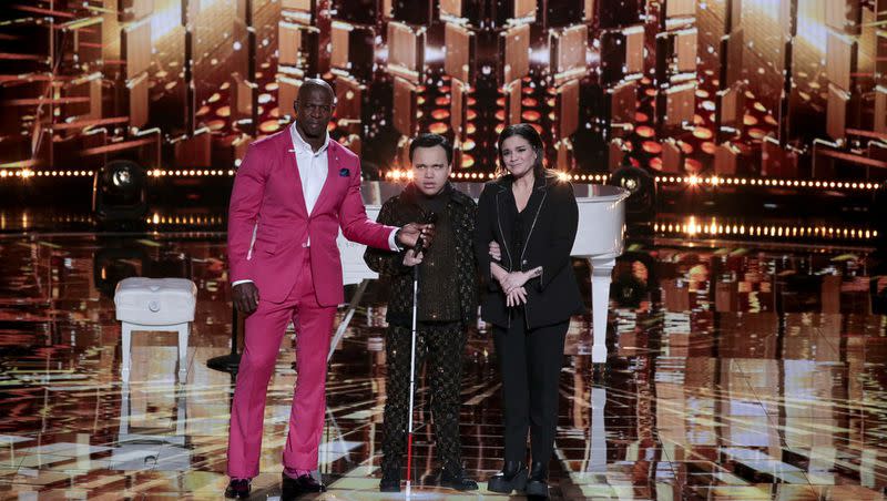 “AGT: Fantasy League” host Terry Crews stands with Kodi Lee and his mom, Tina Lee, during the semifinal round of the “AGT” spinoff.